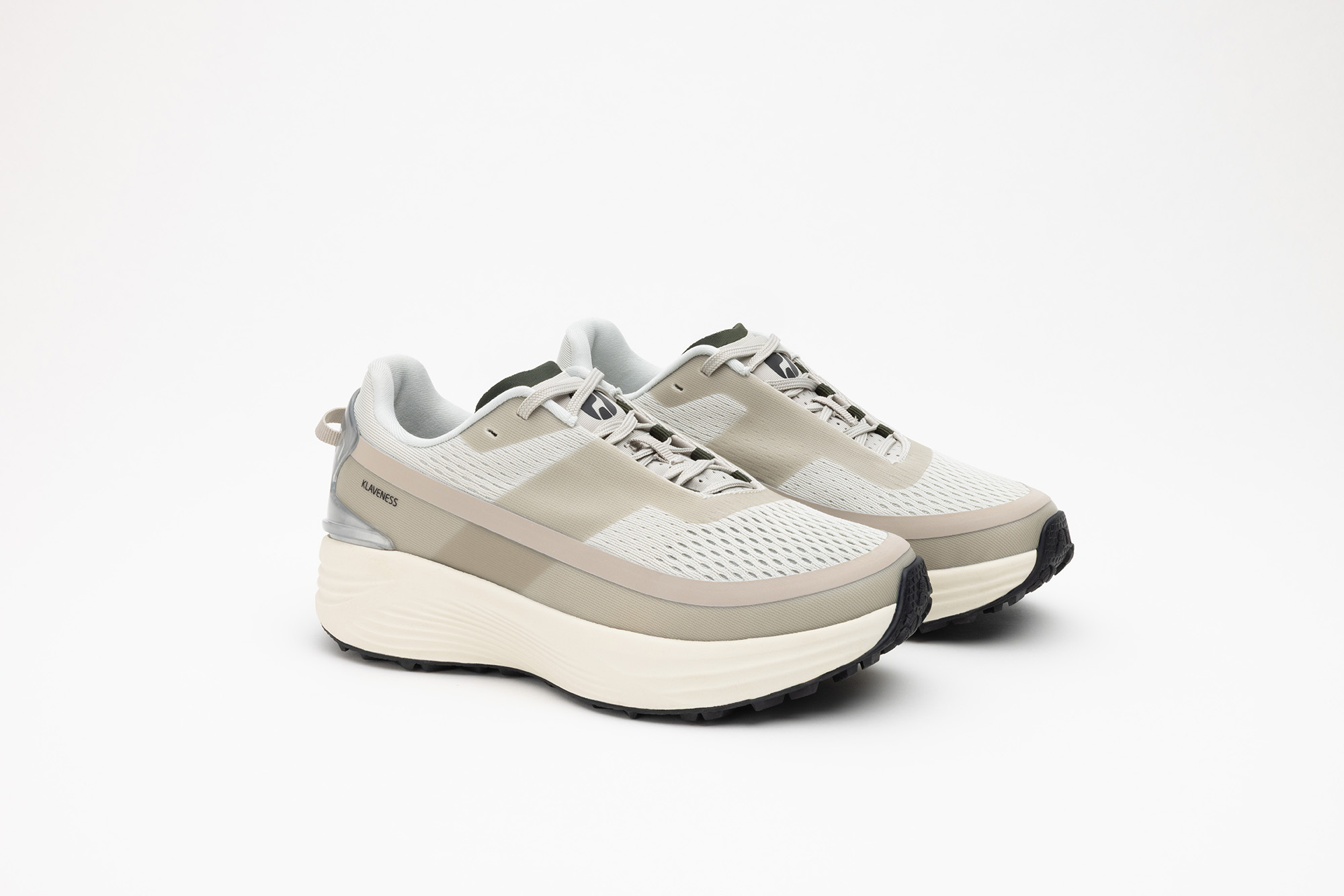 A pair of beige PSGEN3 sneakers from the front at an angle.