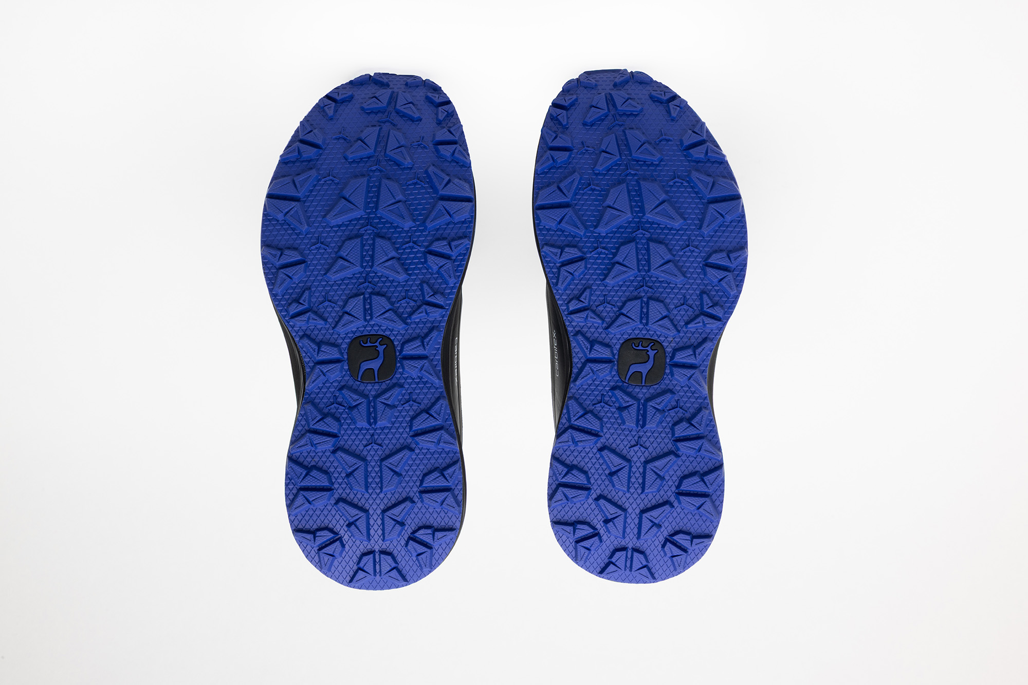 The cobalt blue outsoles of the black PSGEN3 sneakers.