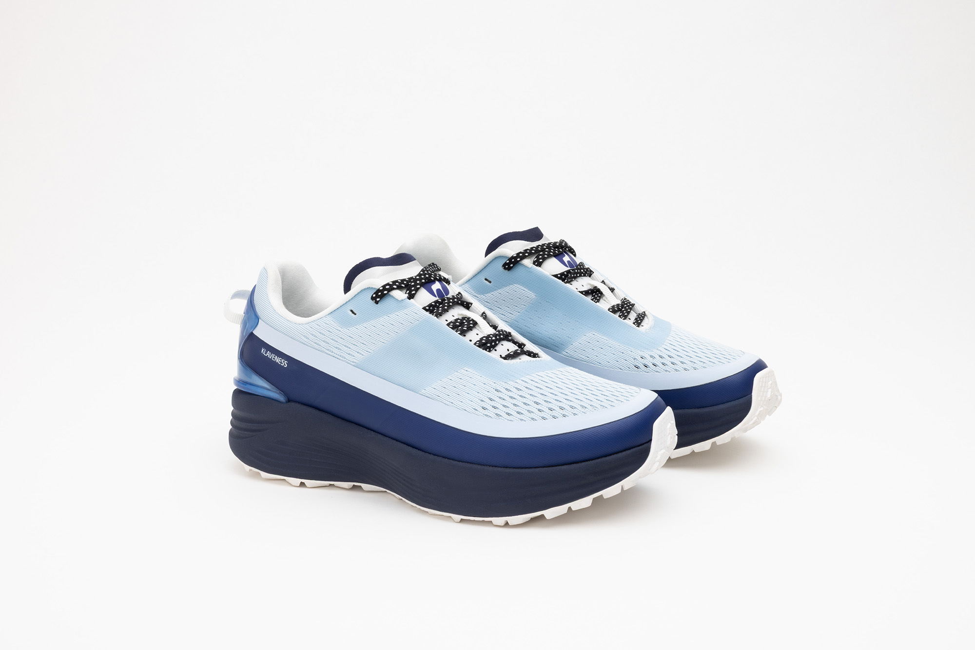A pair of pale blue PSGEN3 sneakers from the front at an angle.